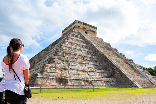 Back View of Woman Looking on Old Ancient Ruins Of Chichen Itza, Temple of Kukulcan. Pre - Columbian Mayan City
