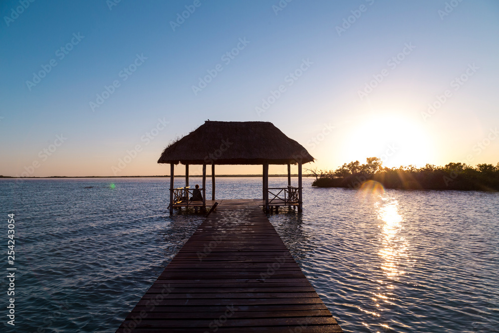 Sunrise, meditation in the lagoon of the seven colors, in Bacalar, Quintana Roo, Mexico.