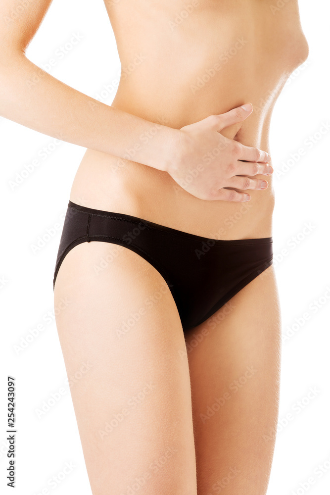 Thin belly of young woman with anorexia. Nutrition disease concept. Thin belly of young woman with anorexia. Nutrition disease concept.