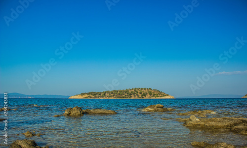 idyllic picturesque scenery landscape wallpaper pattern of lonely island in Mediterranean sea water outdoor environment, view from rocky stone coast line beach, travel vacation photography concept