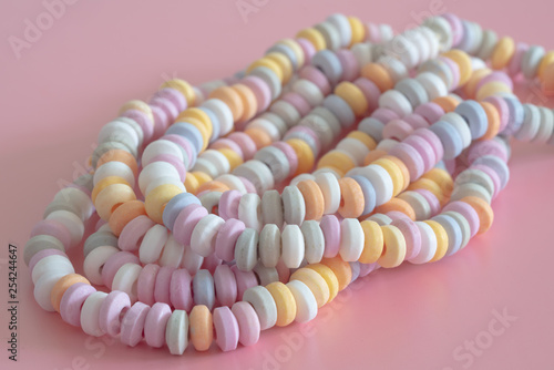 sweets Beads and bracelets candy on a pink background