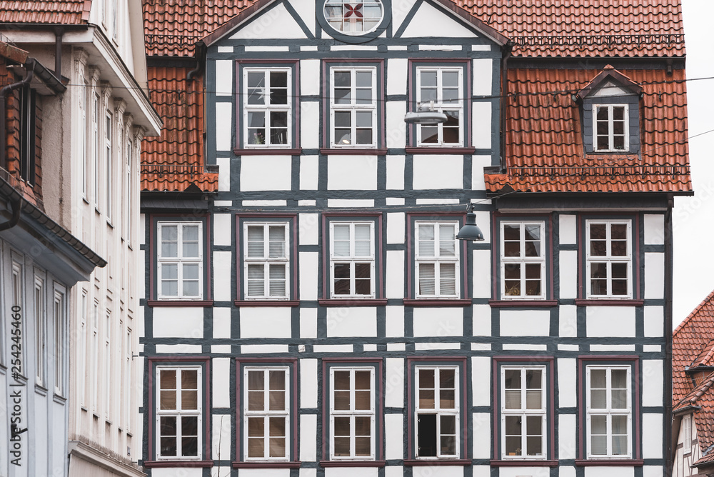 front of a half-timbered house with lot of windows in a German city
