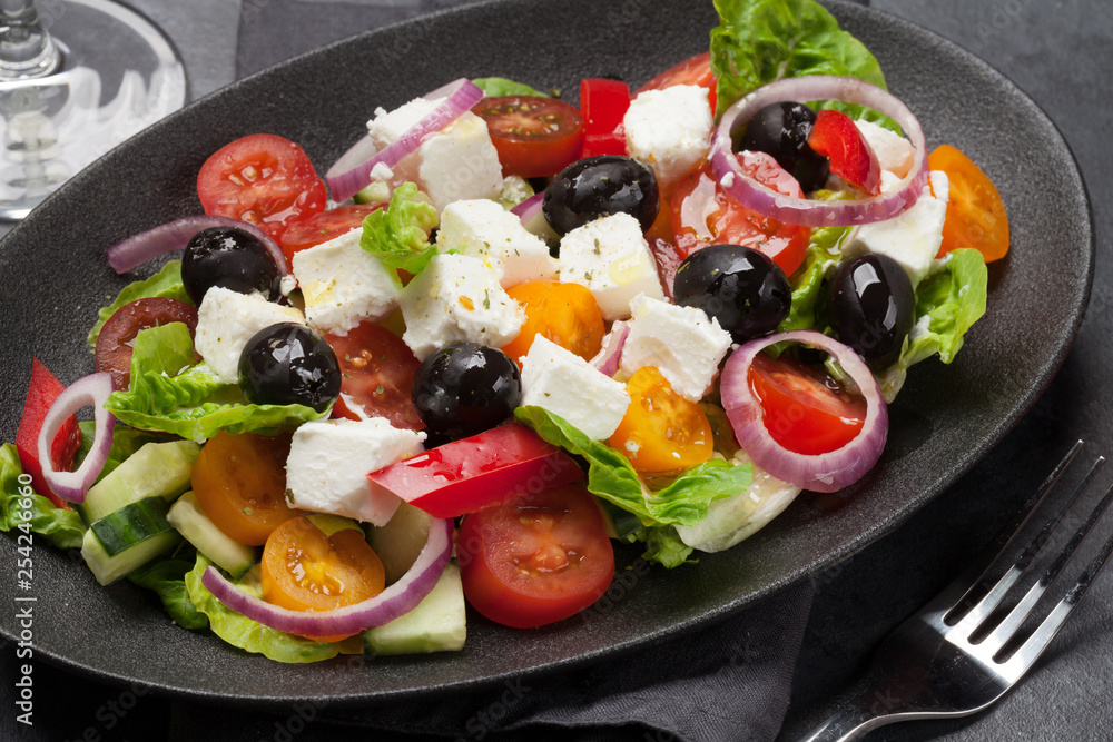 Greek salad plate and white wine Greek salad plate and white wine