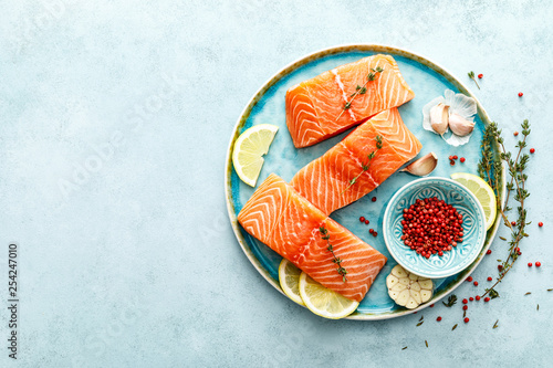 Seafood. Fresh raw salmon or trout fillets with ingredients, top view, space for a text photo