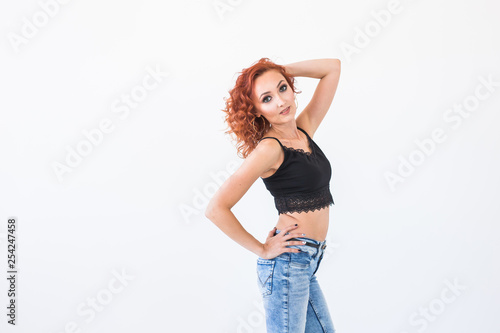Modeling, fashion, people concept - young woman, model near the wall, white background with copy space