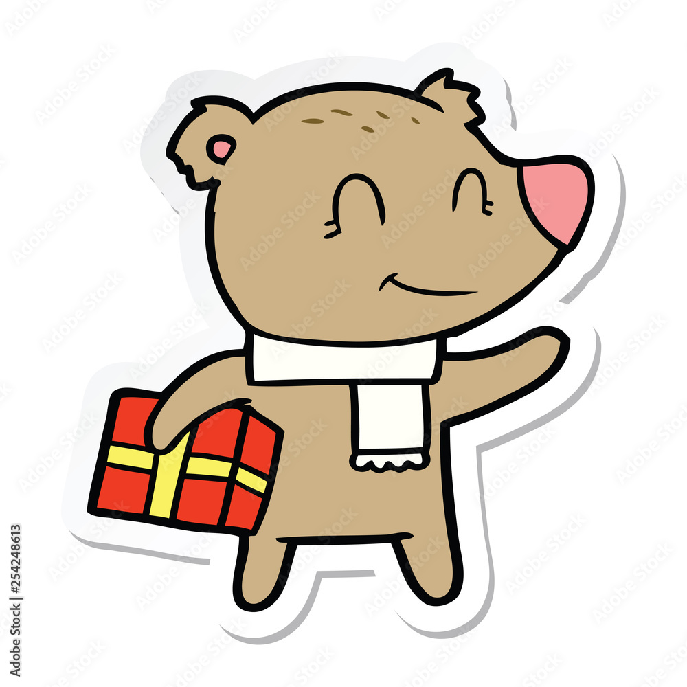 Fototapeta premium sticker of a friendly bear with xmas gift and scarf