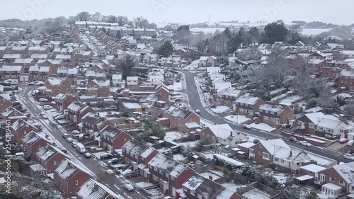Low dolly forward drone shot of snowy Exeter subburbs photo