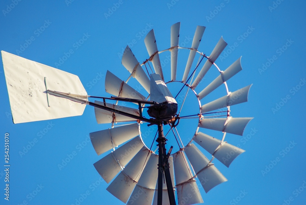 Close up of old style Windmill blades with blue sky