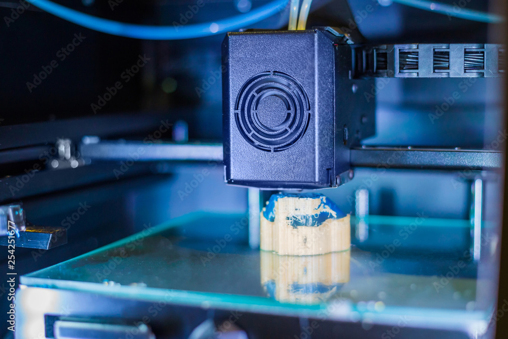 Fototapeta premium Three dimensional printing machine printing 3D plastic model at modern technology exhibition. 4.0 industrial revolution, additive manufacturing, 3D printing and robotic automation technology concept