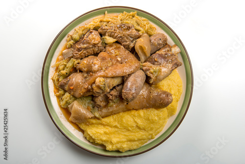 Plate with pork meat and savoy cabbage and polenta