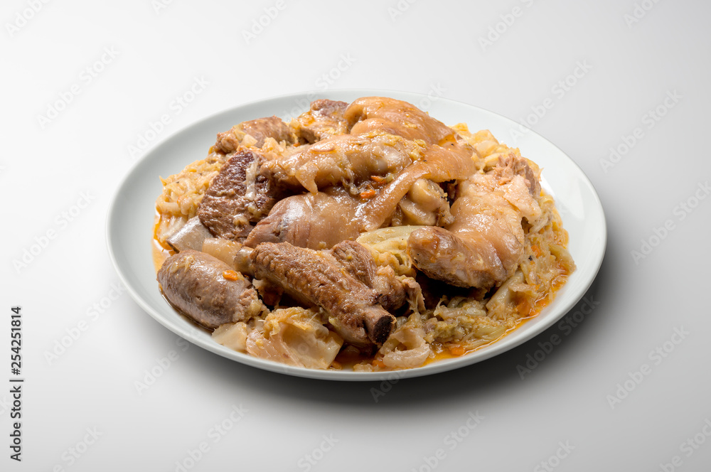 White plate with pork meat and savoy cabbage White plate with pork meat and savoy cabbage