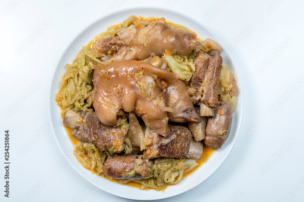 White plate with pork meat and savoy cabbage White plate with pork meat and savoy cabbage