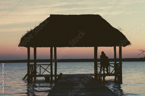 Bacalar  Mexico -January 20 2019  Friends watching the sunset at the pier of the Bacalar Lagoon lagoon of the seven colors  Quintana Roo Mexico