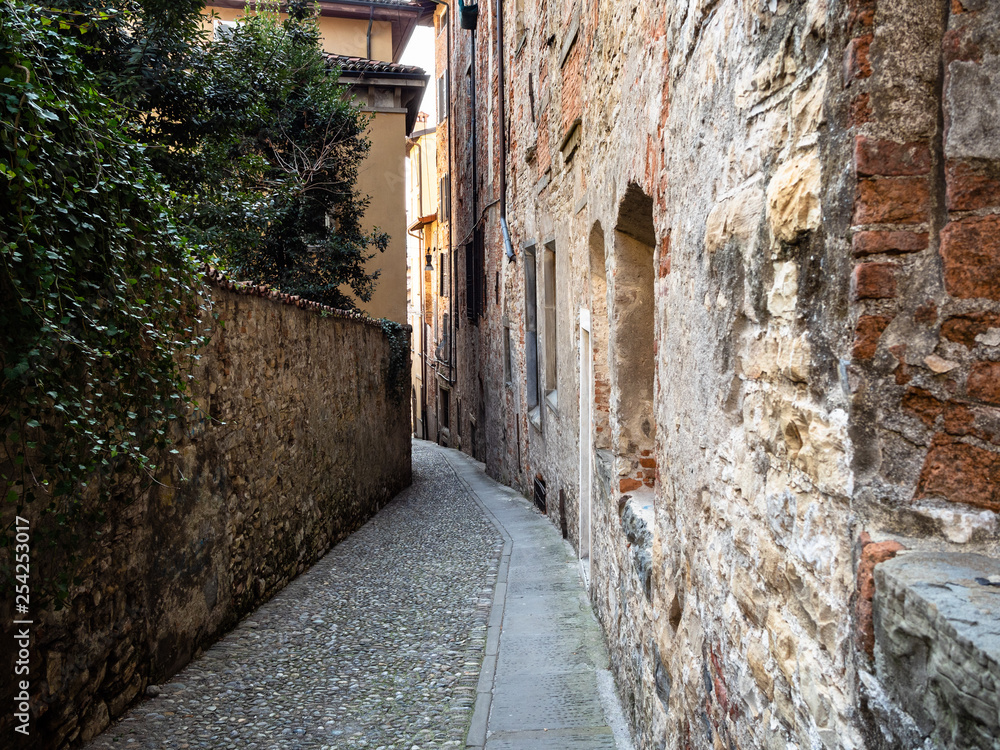 narrow street between medieval houses in Bergamo