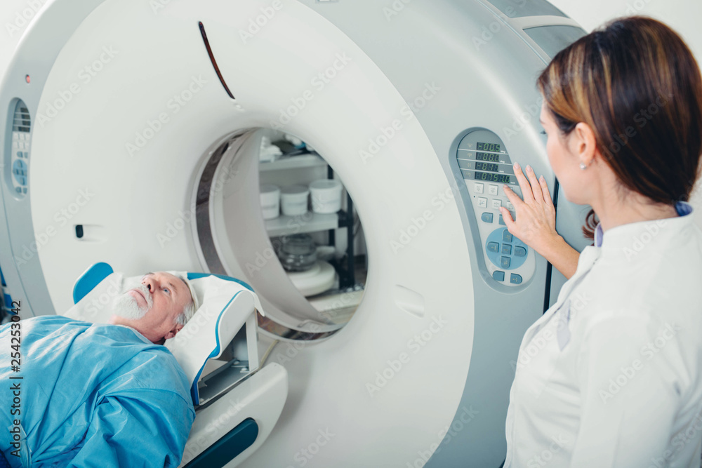 preparing scanner for senior patient , going into CT scanner in hospital preparing scanner for senior patient , going into CT scanner in hospital