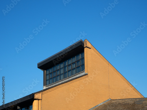 Exterior of modern roof with window against blue sky. Bracknell Forest Berkshire