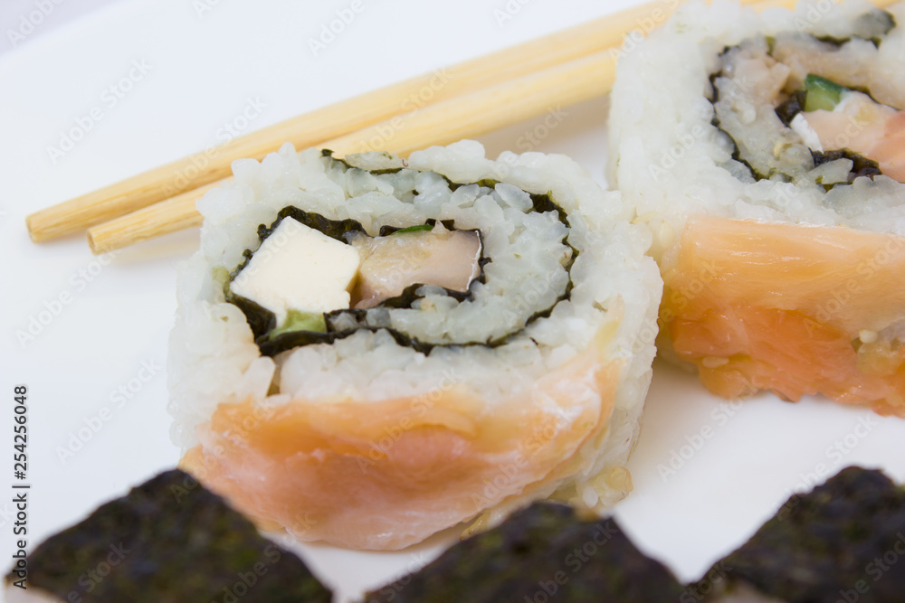 Japanese cuisine, rice sushi and fish - closeup Japanese cuisine, rice sushi and fish - closeup