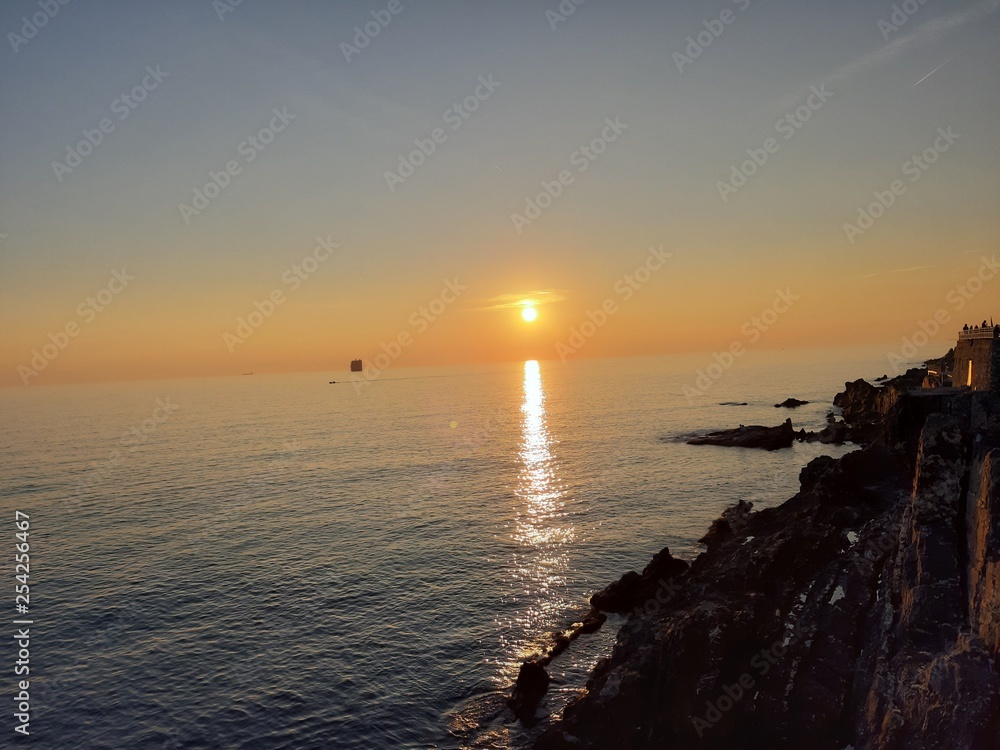 An amazing caption of small waves and beautiful sunset with an incredible reflection over the sea and some coloured clouds in winter days An amazing caption of small waves and beautiful sunset with an incredible reflection over the sea and some coloured clouds in winter days