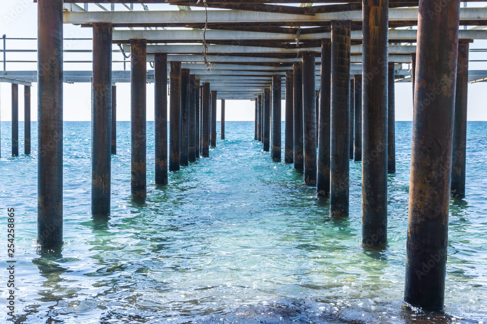 view of the sea under the metal pier view of the sea under the metal pier