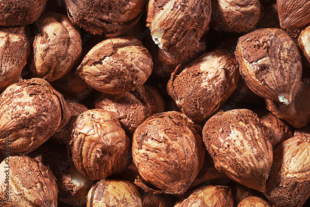 Peeled hazel nuts as background. Organic hazelnuts, top view close-up. Peeled hazel nuts as background. Organic hazelnuts, top view close-up.