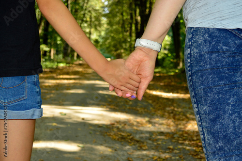 Mom and daughter hold hands