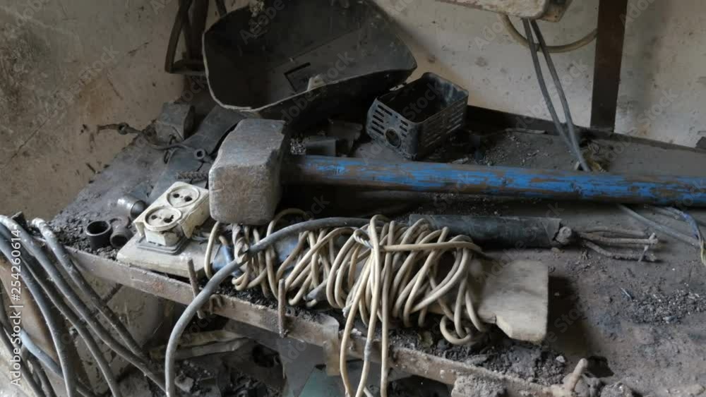 Old Tools, Spare Parts, Electrical Wire And Rubbish Workplace In The Workshop. Old Tools, Spare Parts, Electrical Wire And Rubbish Workplace In The Workshop.
