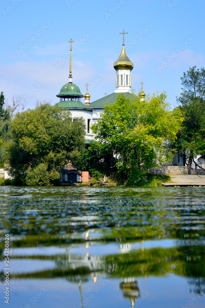 The church on the banks of the river is reflected in the water