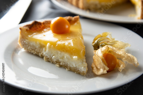 Lemon curd pie. Piece, slice of homemade delicious pie ,tart filled with lemon curd. Sweet dessert. Lemon curd pie decorated with physalis.