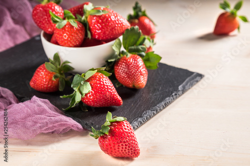 Heap of fresh strawberries on wooden table