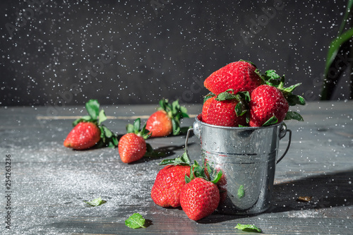 Sugar pouring over strawberries