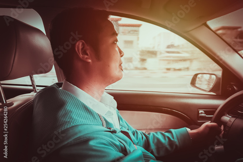 Male person driving his car on the road.-Driving after office concept.-Film look filter. © Dionell