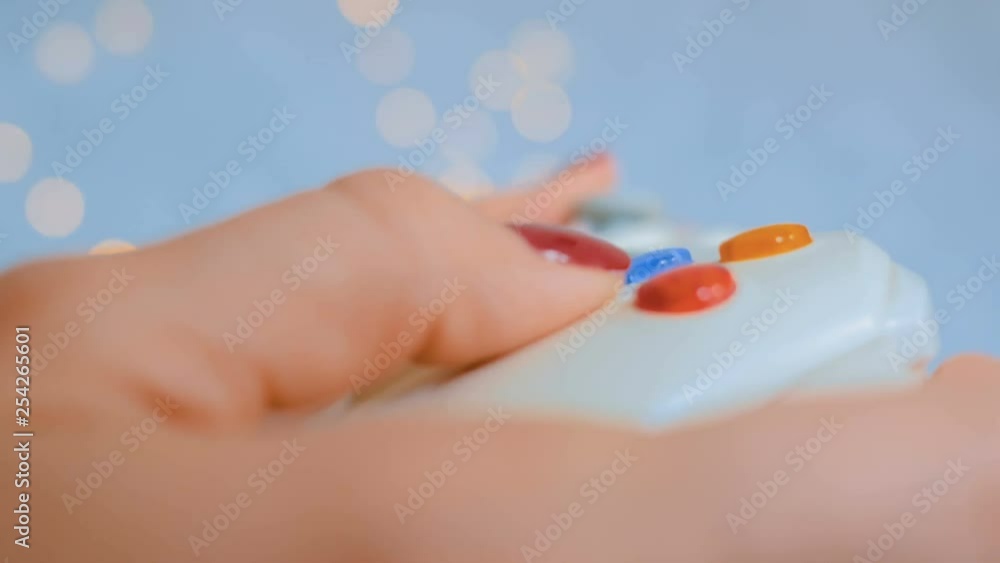 Close up shot of woman hand with joystick or gamepad at home. Gaming, hobby, technology, video game and leisure time concept Close up shot of woman hand with joystick or gamepad at home. Gaming, hobby, technology, video game and leisure time concept