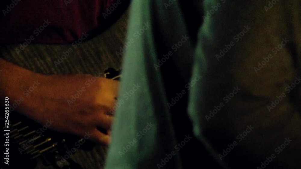 Close up of a man playing the guitar during a concert at a corporate event. Light screen behind him. 50fps frame rate. Close up of a man playing the guitar during a concert at a corporate event. Light screen behind him. 50fps frame rate.