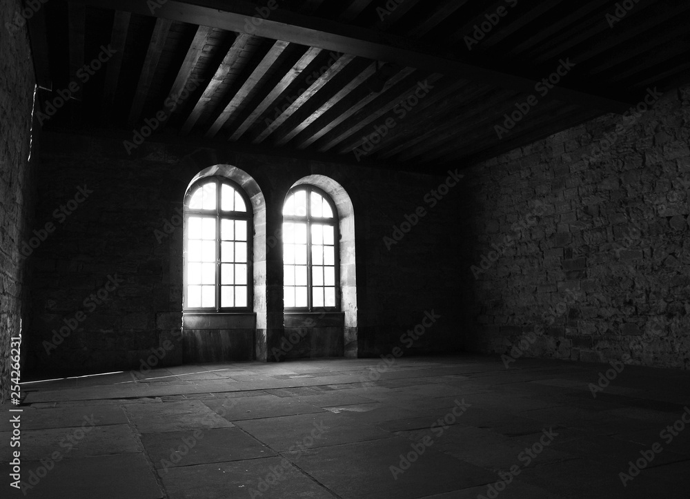 daylight throug windows in empty old building dark room
