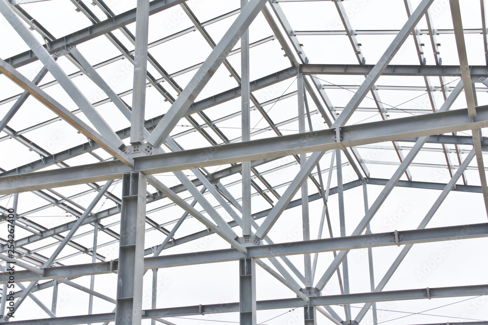 Structure of building from galvanized metal. Steel construction on sky background. Metal galvanizing technology to prevent corrosion.