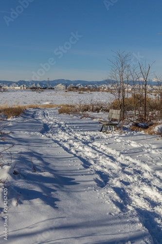 Bench next to snowy path, Rocky Mountain Arsenal, National Wildlife Refuge, Colorado, USA. © Colophotos