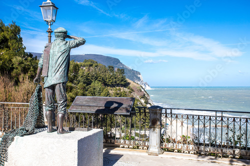 Statue of fisherman and Mount Conero - Numana Sirolo Ancona Marche Italy photo