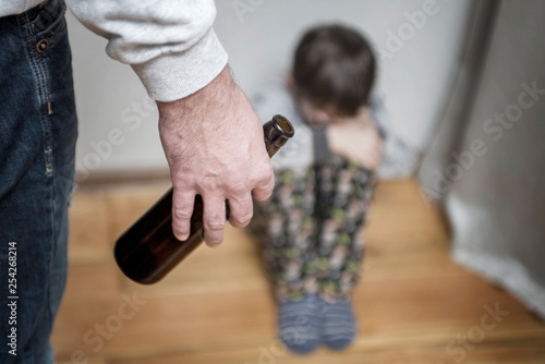 Drunk parent and little scared son. Violence against children concept. Aggression in the family. Alcohol abuse. Domestic violence