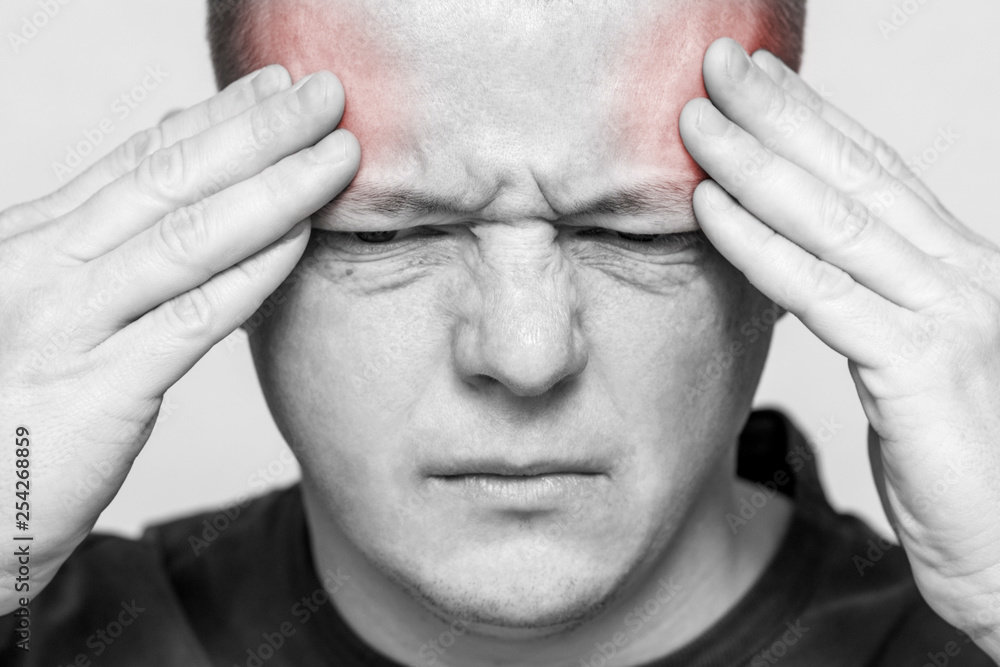 Naklejka premium Terrible headache. Man having a headache. Young man suffering from headache. Man hold his had and suffering from headache, pain, migraine, sad depressed