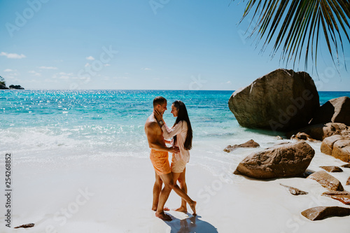honeymoon couple relax on beach in tropics photo