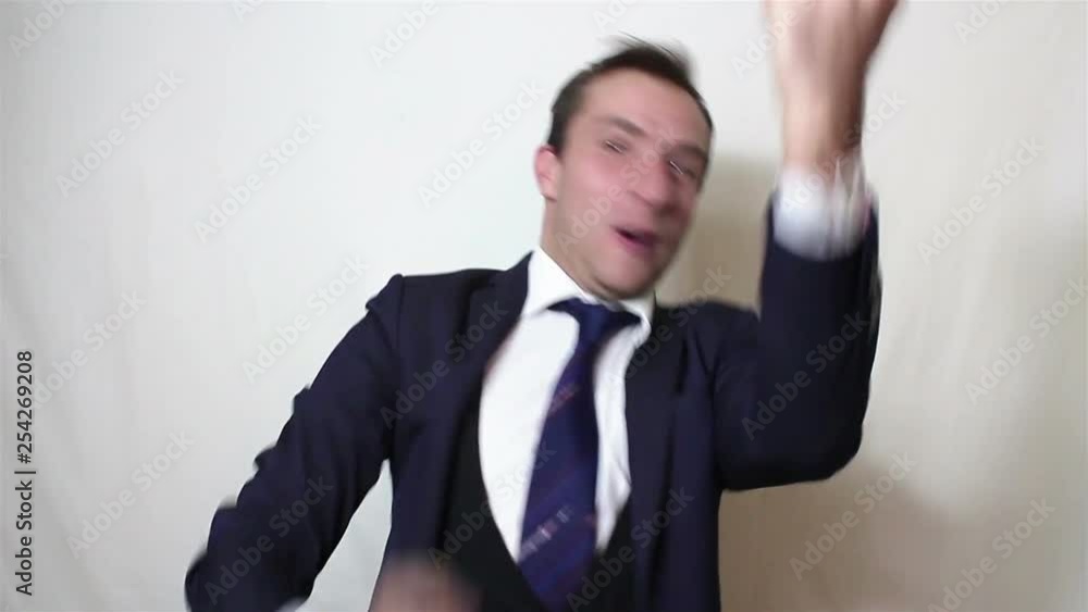 Handsome young businessman actively expresses joy clapping and loud laughing.Portrait on a white background. Handsome young businessman actively expresses joy clapping and loud laughing.Portrait on a white background.