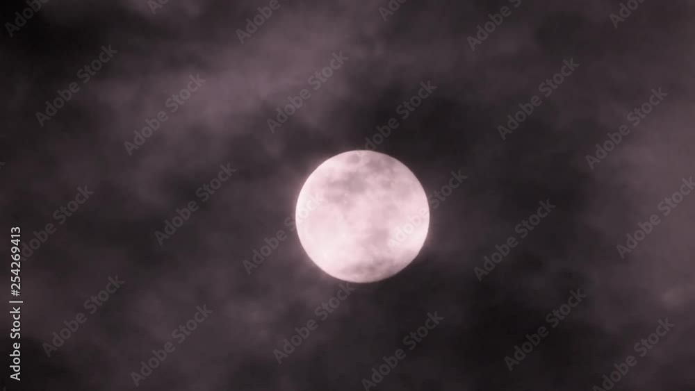 Black and white moon with cloud coverage close up Black and white moon with cloud coverage close up