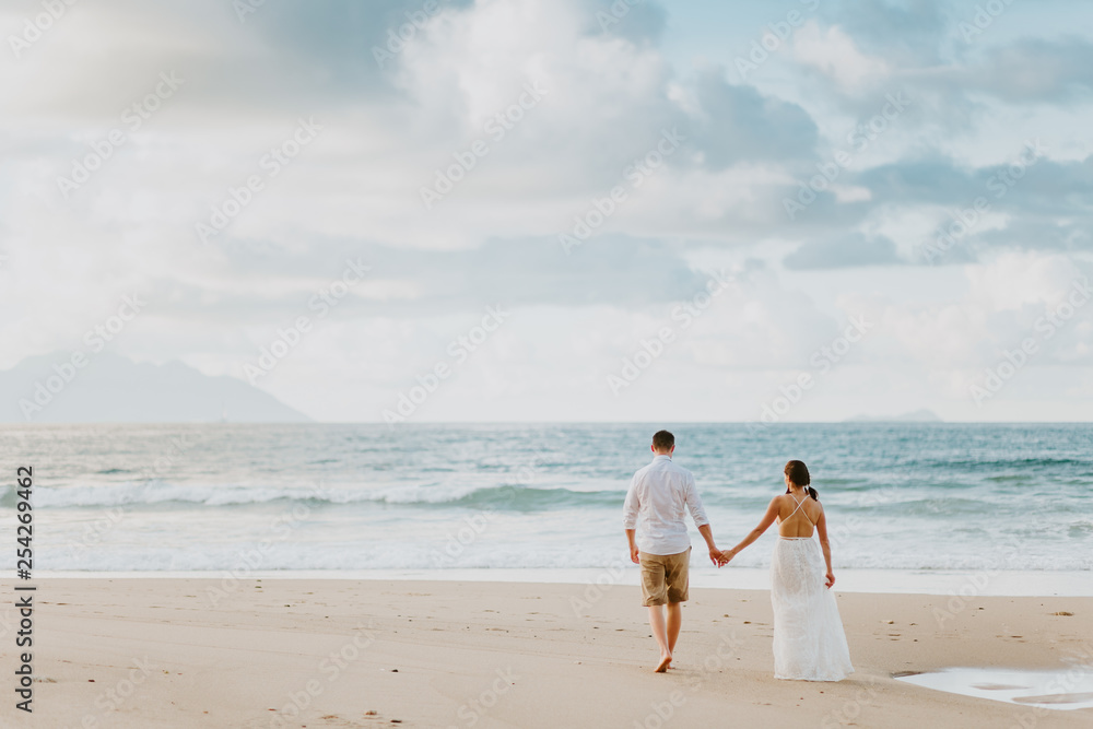 honeymoon wedding couple on beach at sunset honeymoon wedding couple on beach at sunset