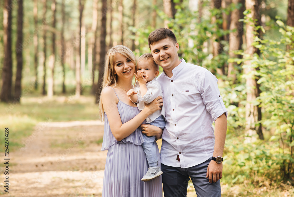 Fototapeta premium Happy young family spends time together in nature.