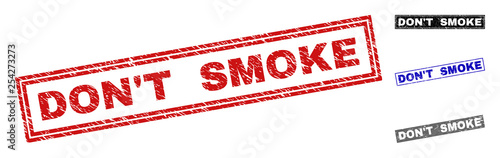 Grunge DON'T SMOKE rectangle stamp seals isolated on a white background. Rectangular seals with grunge texture in red, blue, black and grey colors.