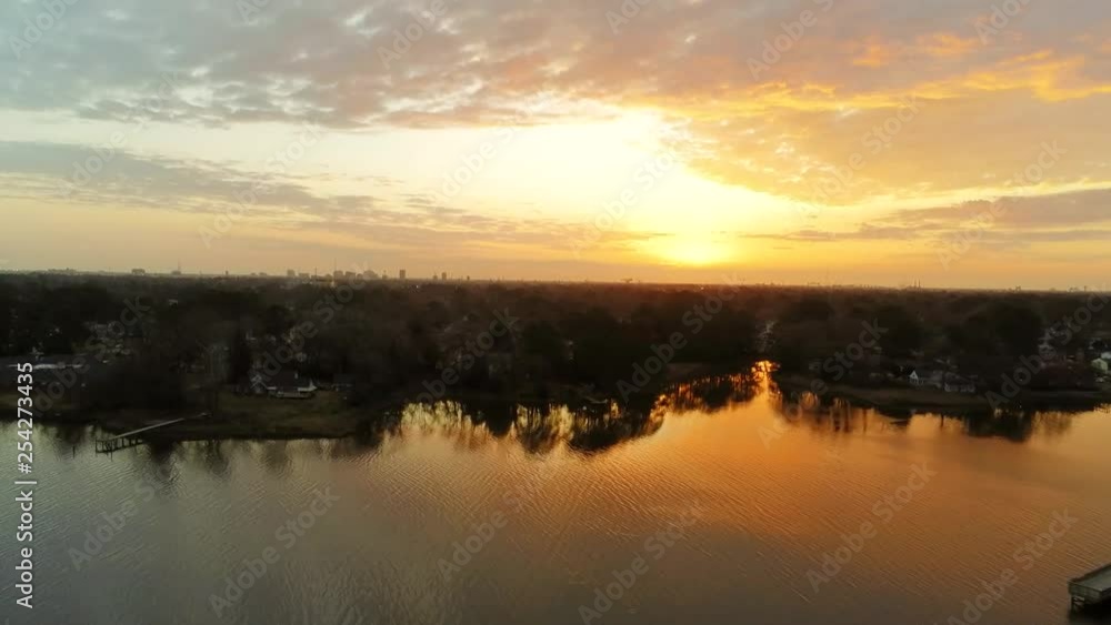 Shot over Portsmouth, a drone reveal of the City of Norfolk Virginia bathed in golden light of the morning sunrise. The golden color is reflected in the Western Branch of the Elizabeth River. Shot over Portsmouth, a drone reveal of the City of Norfolk Virginia bathed in golden light of the morning sunrise. The golden color is reflected in the Western Branch of the Elizabeth River.