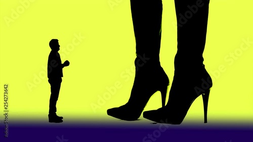 Woman and high-heeled boots dominate a pleading man and kick him dan with the shoe tip away.