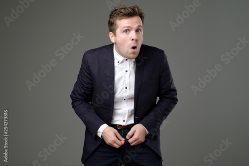 Canvas Print Man in suit zip his pants up. Problem with broken fly.