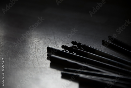 Close up of a bunch of chop sticks in black and white