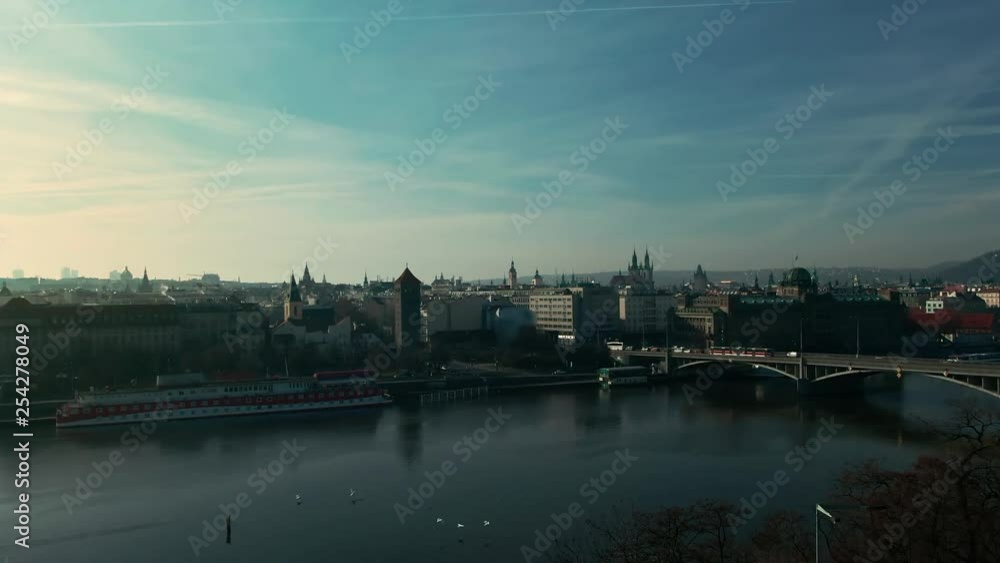 drone flight over prague vlatava river showing bridges castle park and buildings winter sunshine drone flight over prague vlatava river showing bridges castle park and buildings winter sunshine